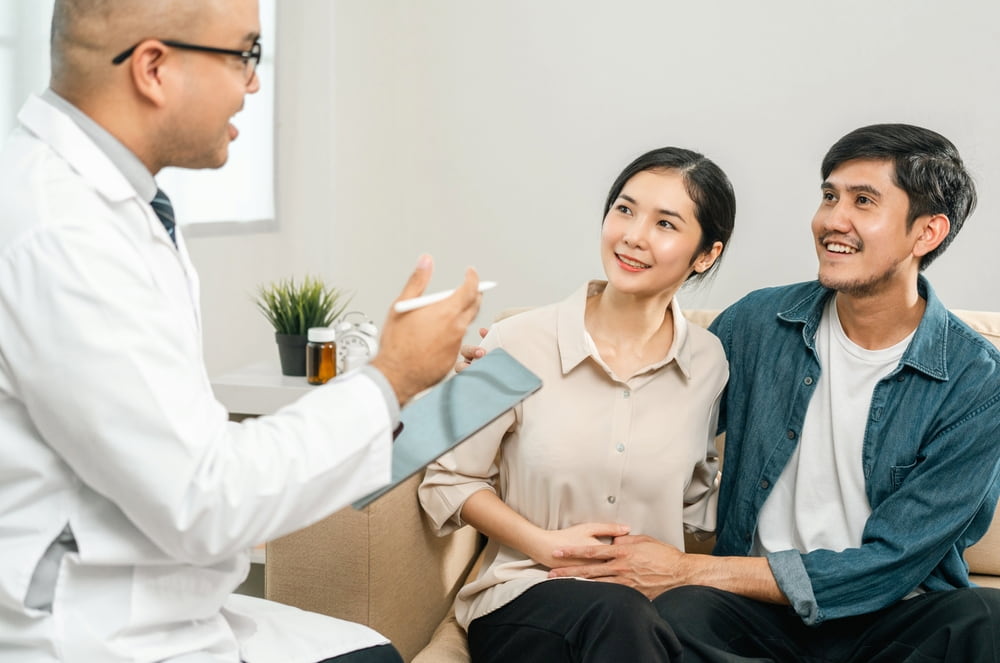 Couple discussing ICSI treatments with their doctor.