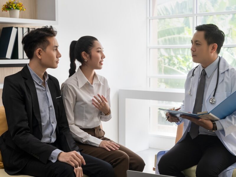 A young couple consulting with a doctor.