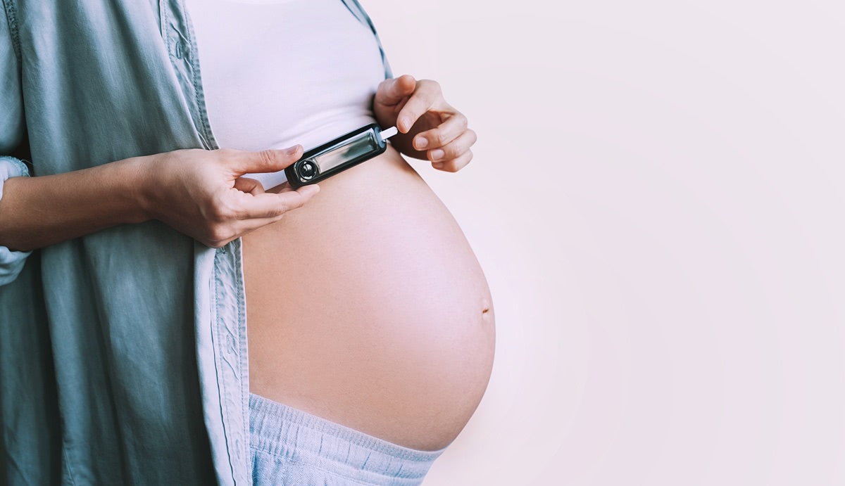 A pregnant woman checks blood sugar levels