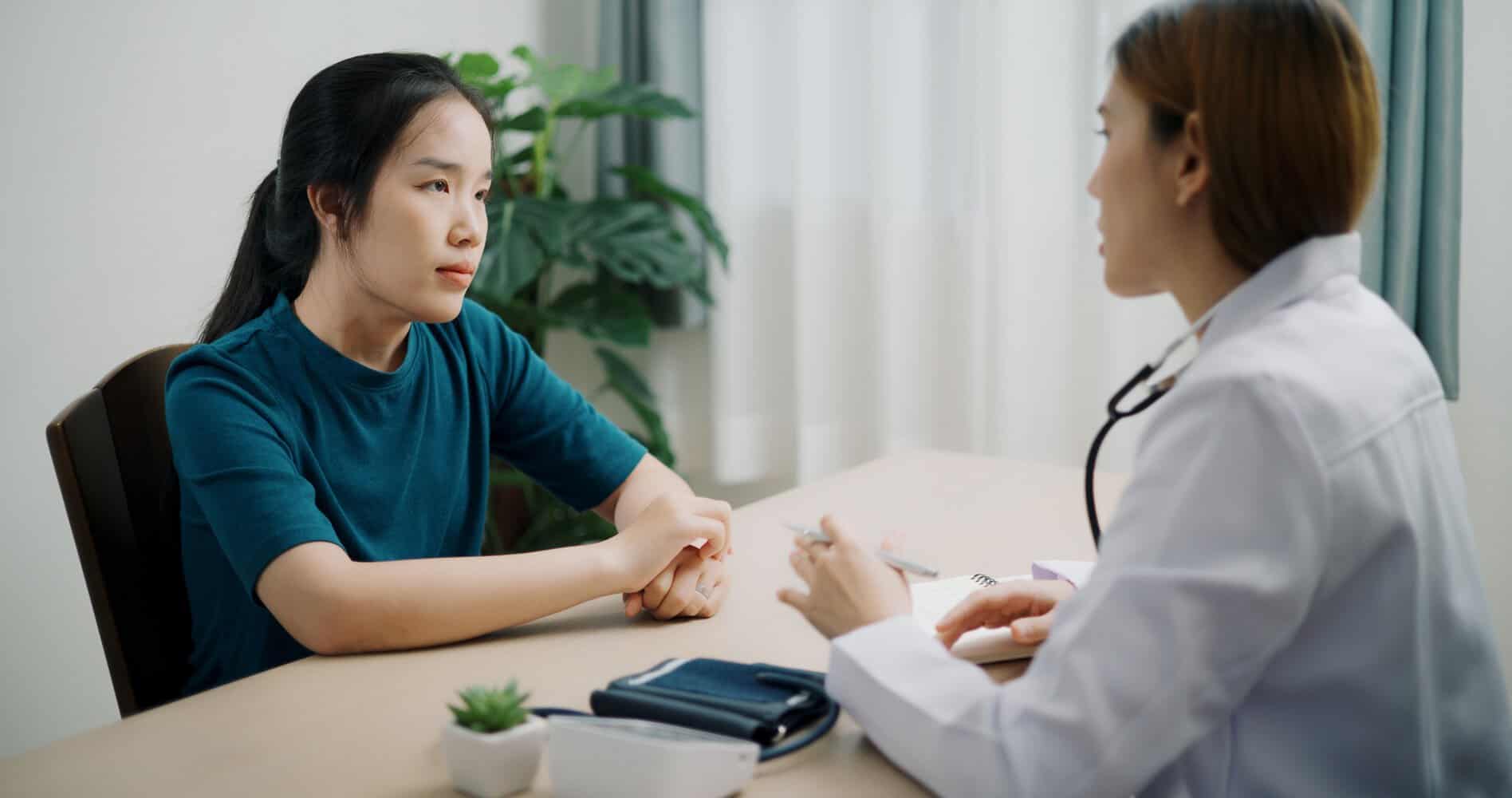 A fertility doctor consults with her patient.